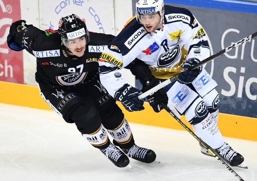 Lugano&#039;s player Dario Buergler, left, fights for the puck with Ambri&#039;s player Marco Mueller, right, during the preliminary round game of National League Swiss Championship 2018/19 between Sw ...