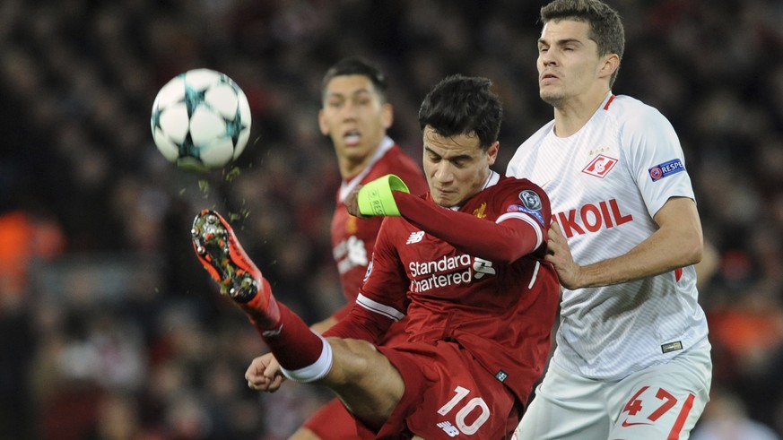 Liverpool&#039;s Philippe Coutinho, left, challenges for the ball with Spartak&#039;s Roman Zobnin during the Champions League Group E soccer match between Liverpool and Spartak Moscow at Anfield, Liv ...