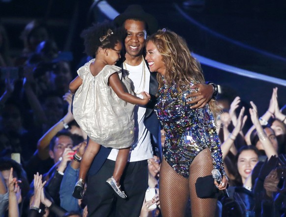 Beyonce smiles with Jay-Z and daughter Ivy Blue after accepting the Video Vanguard Award on stage during the 2014 MTV Video Music Awards in Inglewood, California August 24, 2014. REUTERS/Lucy Nicholso ...
