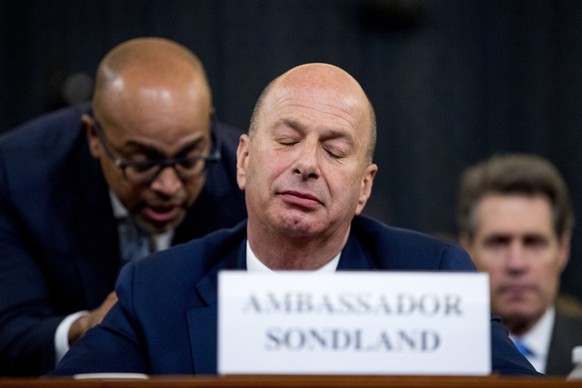 Ambassador Gordon Sondland, U.S. Ambassador to the European Union, center, appears before the House Intelligence Committee on Capitol Hill in Washington, Wednesday, Nov. 20, 2019, during a public impe ...