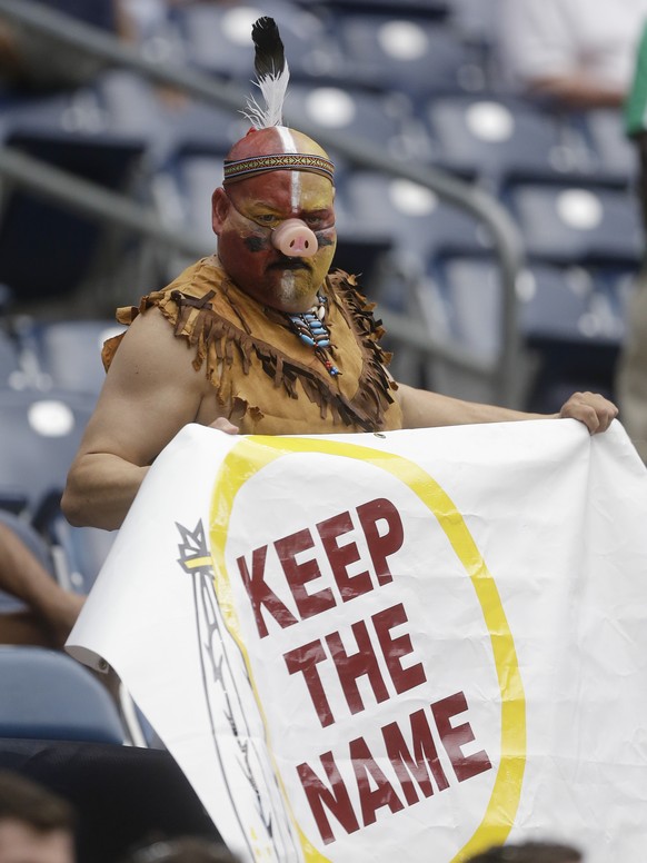 A fan holds a sign in support of the Washington Redskins&#039; name before an NFL football game against the Houston Texans, Sunday, Sept. 7, 2014, in Houston. (AP Photo/Patric Schneider)