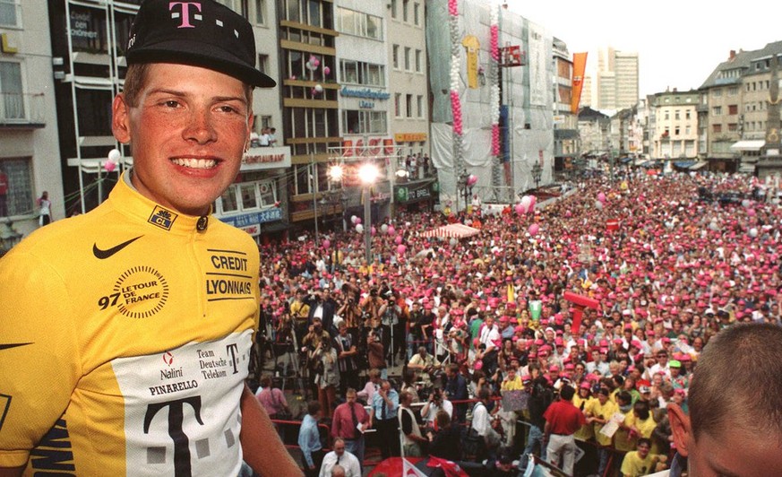 Germany&#039;s Tour de France winner Jan Ullrich presents his yellow shirt to the crowd of fans in Bonn, Germany, in this July 28, 1997 photo, during a reception for the German Telekom cycling team at ...