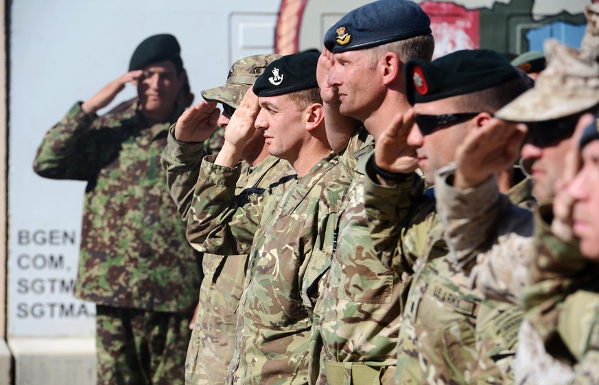 epa04464125 A handout image made available by British Defence Ministry, MOD, dated 26 October 2014 and showing soldiers attending the ceremony of the British, US and NATO flags being lowered at the Ca ...