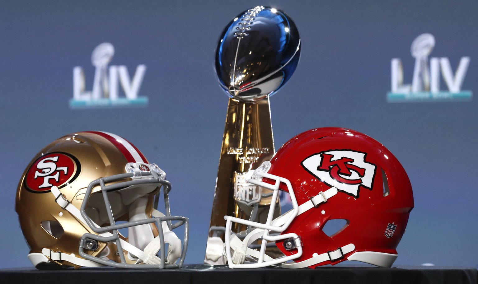 epa08176223 The NFL Super Bowl Vince Lombardi trophy on display with the NFC Champions San Francisco 49ers helmet and the AFC Champions Kansas City helmet before the NFL Commissioner Roger Goodell pre ...