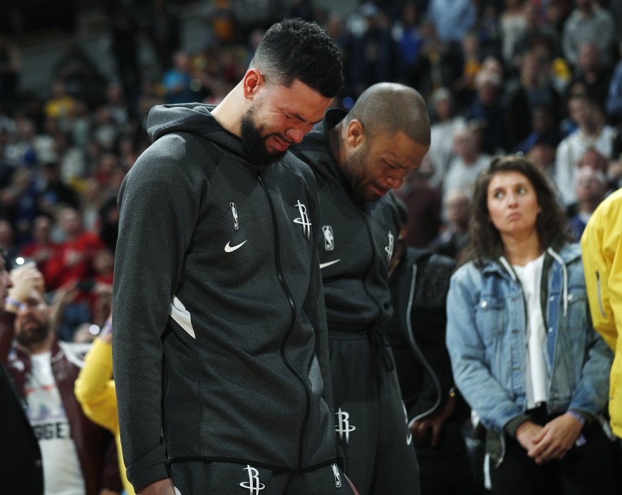 Houston Rockets guard Austin Rivers and forward P.J. Tucker react during a tribute to NBA star Kobe Bryant before an NBA basketball game against the Denver Nuggets, Sunday, Jan. 26, 2020, in Denver. B ...