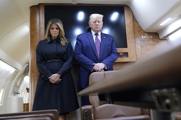 President Donald Trump and first lady Melania Trump pause for a moment of silence on Air Force One as he arrives at the airport in Johnstown, Pa., on his way to speak at the Flight 93 National Memoria ...