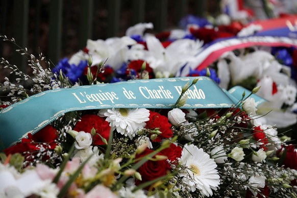 A wreath of flowers is seen outside the satirical newspaper Charlie Hebdo&#039;s former office, before a ceremony to mark the fourth anniversary of the attack in Paris, Monday, Jan. 7, 2019. 2015. Car ...