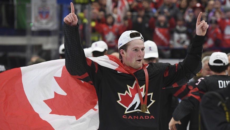 Canada&#039;s Alexis Lafreniere wears a Canadian flag as he celebrates after defeating Russia in the gold medal game at the World Junior Hockey Championships, Sunday, Jan. 5, 2020, in Ostrava, Czech R ...
