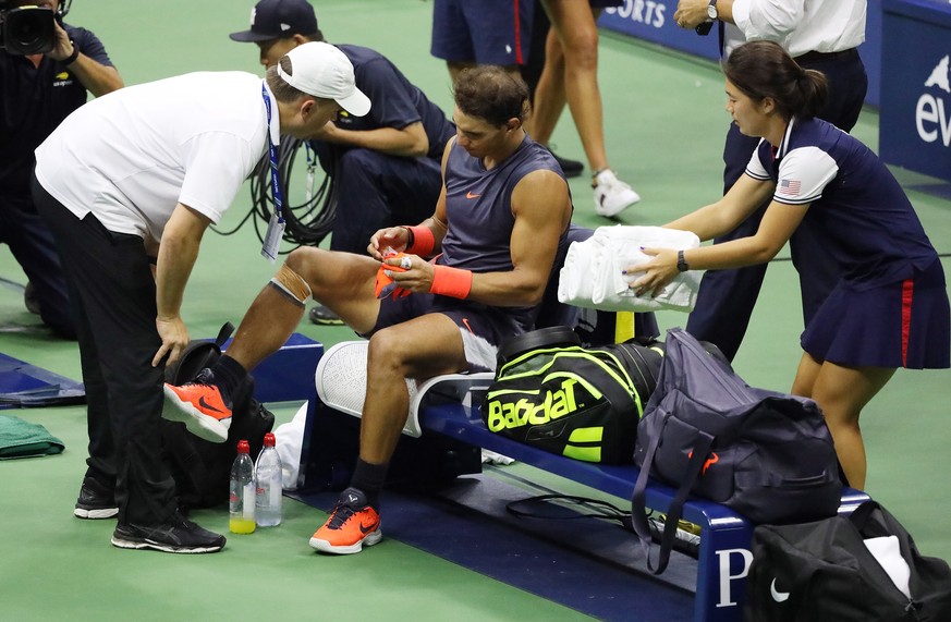 epa07004444 Rafael Nadal of Spain talks with a trainer seconds before retiring as he plays Juan Martin del Potro of Argentina during their semi-final match on the twelfth day of the US Open Tennis Cha ...