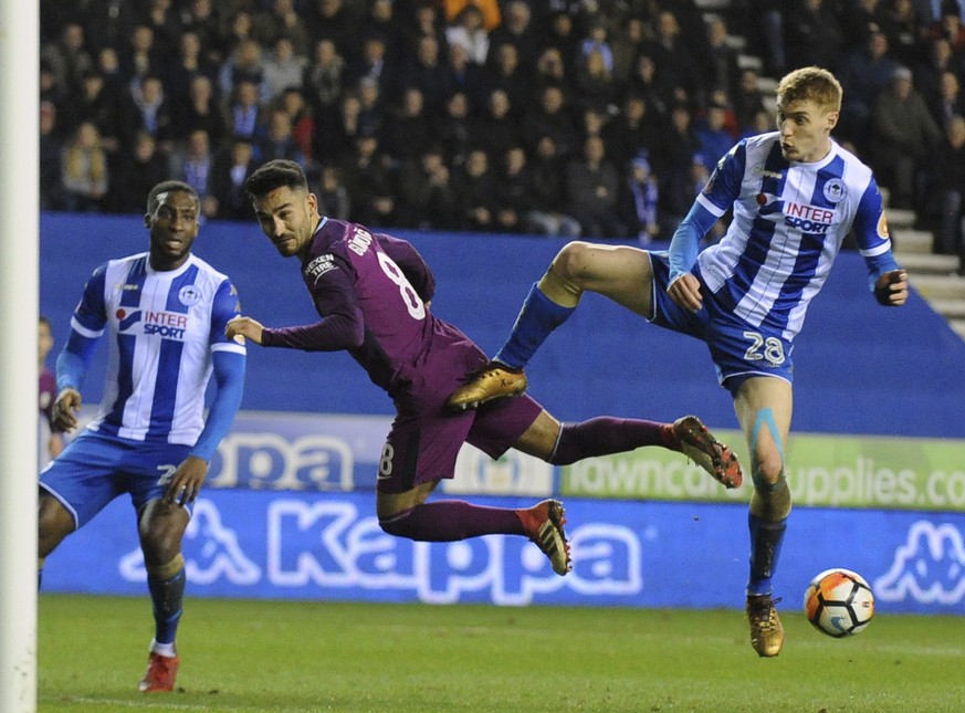 Wigan&#039;s Jay Fulton, right, duels for the ball with Manchester City&#039;s Ilkay Gundogan during the English FA Cup fifth round soccer match between Wigan Athletic and Manchester City at The DW St ...