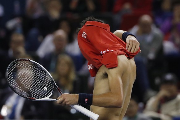 Novak Djokovic of Serbia changes his shirt after losing a point to Roberto Bautista Agut of Spain during the men&#039;s singles semifinals match of the Shanghai Masters tennis tournament at Qizhong Fo ...