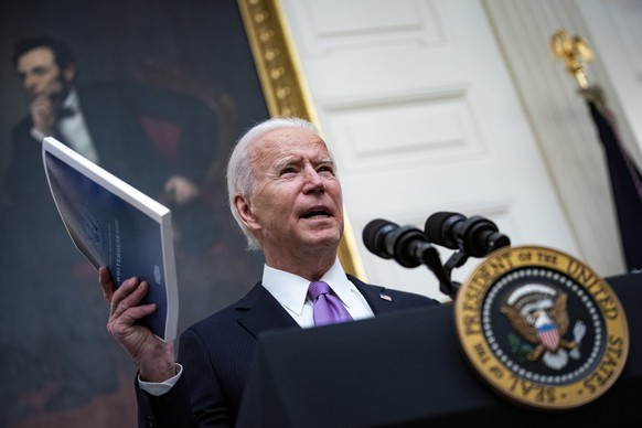 epa08956518 US President Joe Biden speaks on his administration&#039;s Covid-19 response in the State Dining Room of the White House in Washington, DC, USA, on 21 January 2021. Biden in his first full ...