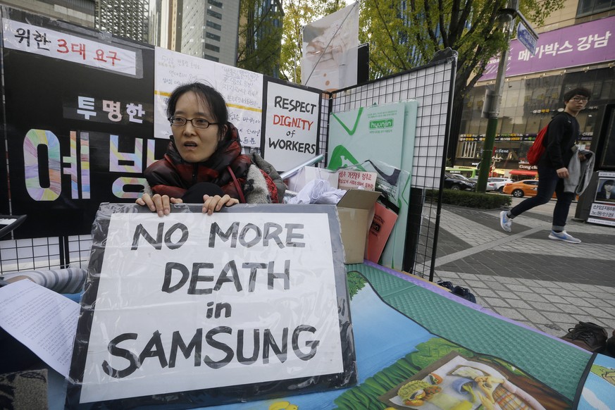 In this Oct. 23, 2015 photo, former Samsung worker Han Hye-kyung, denounces the companys response in its latest negotiations with sick workers, during a protest outside Samsung buildings in Seoul, So ...