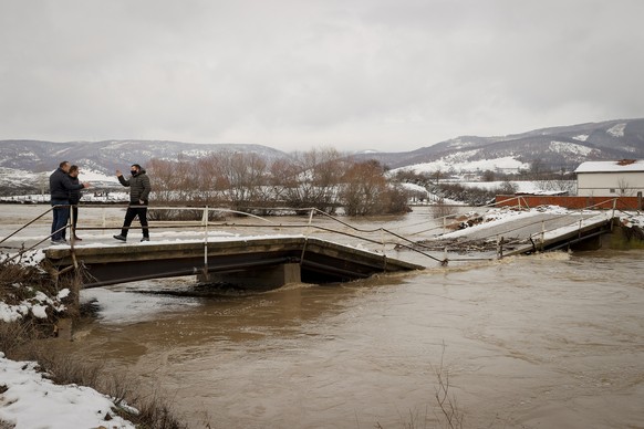 epa08931655 Local resident visit the damaged bridge in the village of Dobroshec, Kosovo, 11 January 2021. Due to heavy rain, the bridge that connects the village of Dobroshec with other parts of the c ...