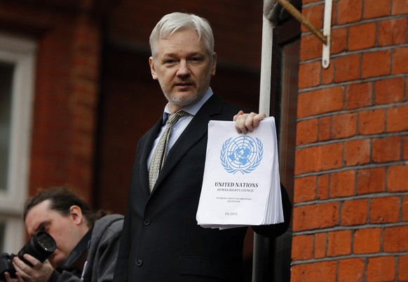 FILE - In this Friday, Feb. 5, 2016 file photo, WikiLeaks founder Julian Assange stands on the balcony of the Ecuadorean Embassy to address waiting supporters and media in London. Police in London arr ...