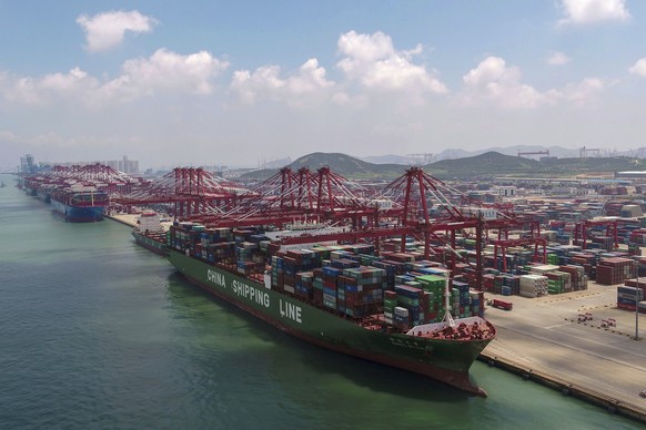 In this Aug. 6, 2019, photo, a container ship is docked a port in Qingdao in eastern China&#039;s Shandong province. U.S. President Donald Trump angrily escalated his trade fight with China on Friday, ...