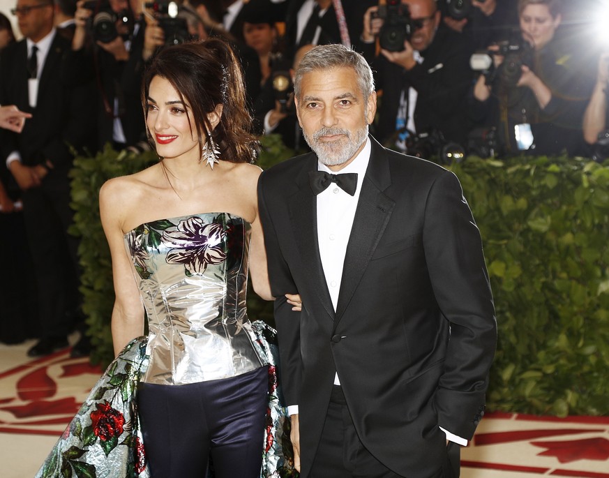epa06717819 George and Amal Clooney arrive on the red carpet for the Metropolitan Museum of Art Costume Institute benefit celebrating the opening of the exhibit ‘Heavenly Bodies: Fashion and the Catho ...