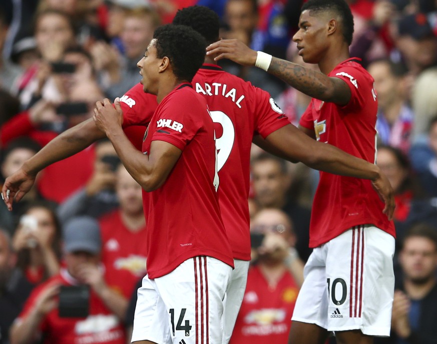 Manchester United&#039;s Marcus Rashford, right, celebrates with teammates after scoring his sides first goal during the English Premier League soccer match between Manchester United and Chelsea at Ol ...
