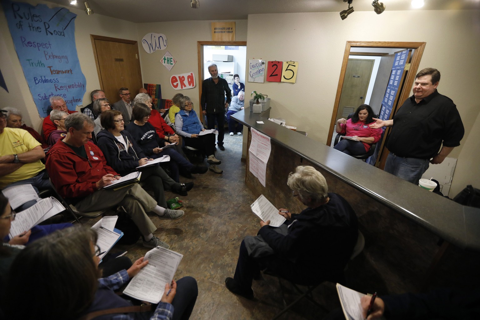 Former Iowa Democratic Party political director Travis Brock, right, leads a caucus training meeting at the local headquarters for Democratic presidential candidate South Bend, Ind., Mayor Pete Buttig ...