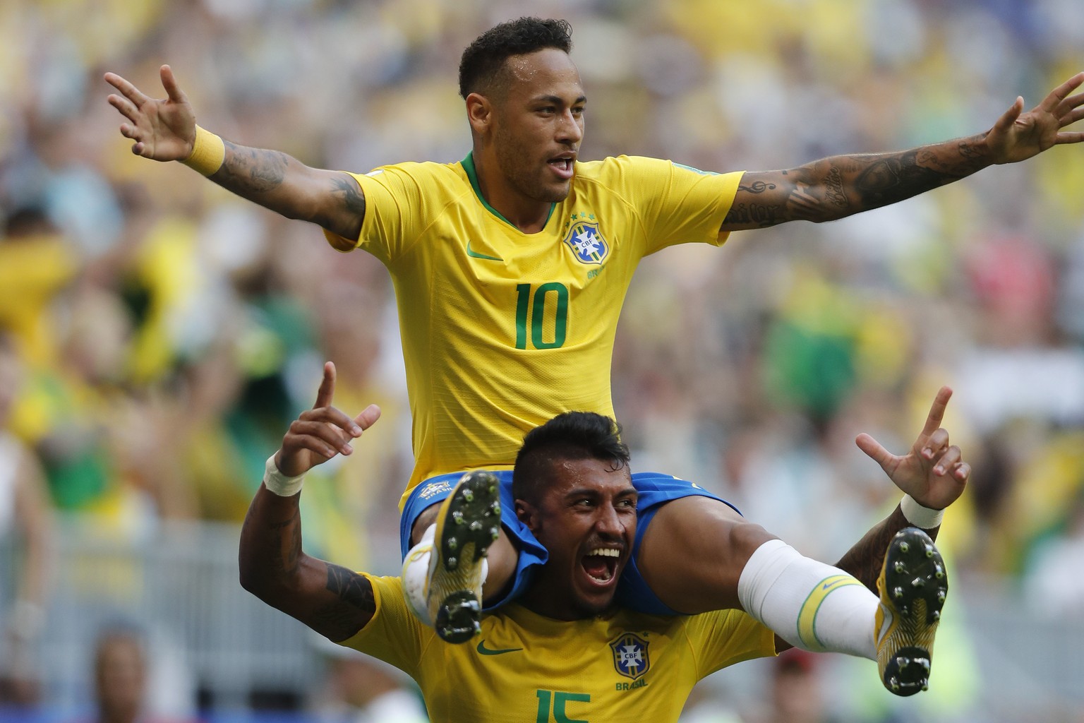 Brazil&#039;s Neymar, top, celebrates with team mate Paulinho after scoring his side&#039;s opening goal during the round of 16 match between Brazil and Mexico at the 2018 soccer World Cup in the Sama ...