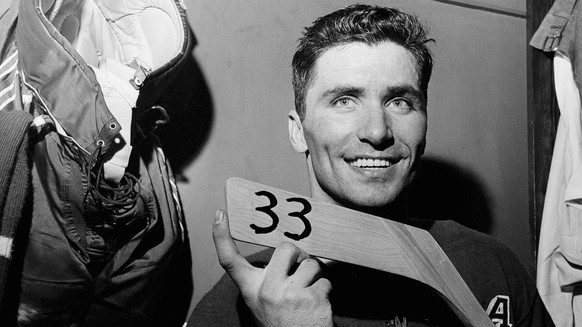 FILE - In this March 1, 1959, file photo, New York Rangers&#039; Andy Bathgate poses with his hockey stick after in the locker room after scoring his 33rd goal of the season in New York. Bathgate, a H ...