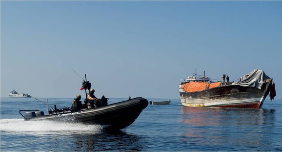 epa04033096 A handout photo dated 18 January 2014, made available 20 January 2014 by the French EU Naval Force (EU NAVFOR) Somalia Operation Atalanta, showing a Dhow (R) being apprehended by members o ...