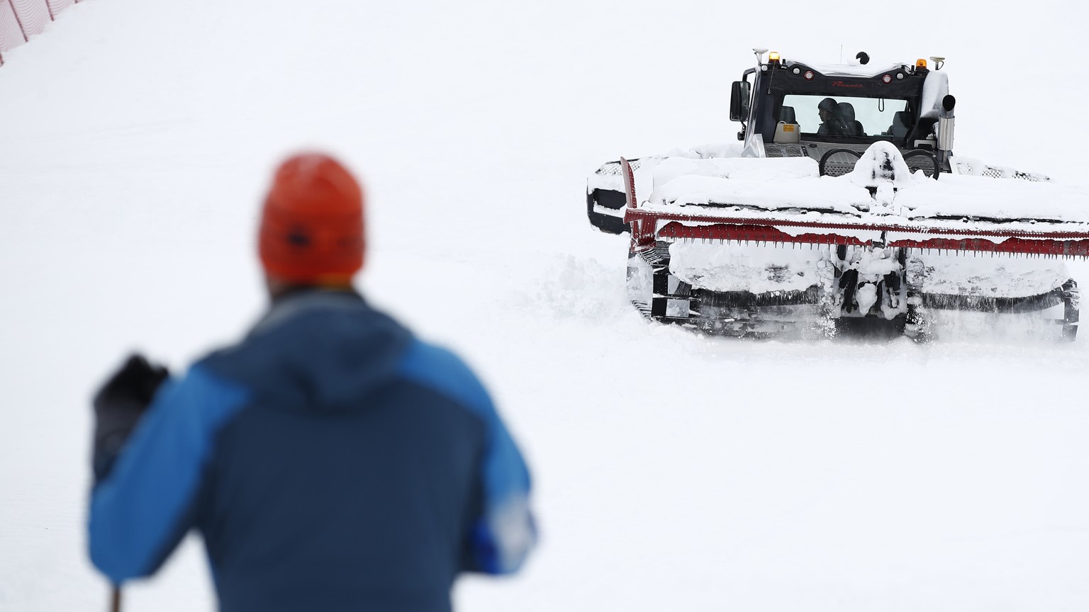 A snow plough is clearing snow on the course as the alpine ski, men&#039;s and women&#039;s World Cup downhill were cancelled due to weather conditions, in Lenzerheide, Switzerland, Wednesday, March 1 ...