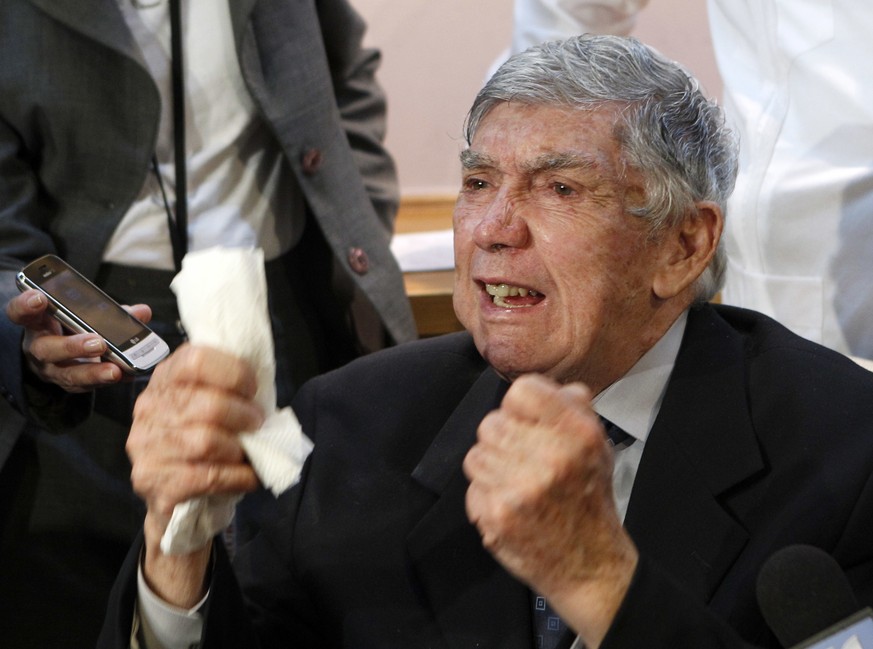 FILE - In this April 13, 2011, file photo, anti-Castro activist Luis Posada Carriles gestures as he responds to a reporter during a news conference in Miami. A lawyer for him said the militant Cuban e ...