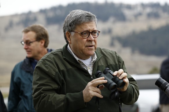 Attorney General William Barr prepares to view bison through a pair of binoculars while visiting the National Bison Range near Moiese, Mont., Friday, Nov. 22, 2019, during a two-day trip to Ohio and M ...