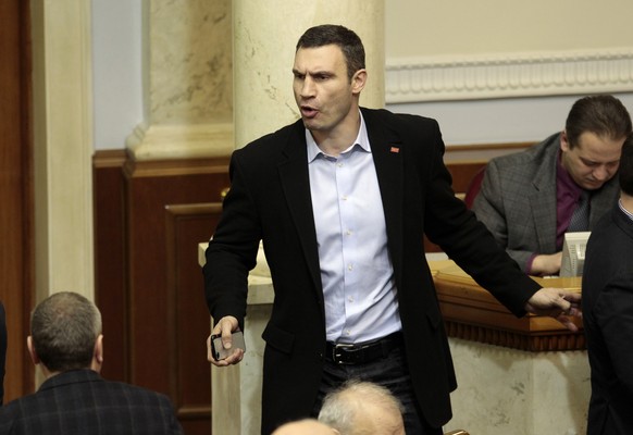 Ukrainian opposition leader and former WBC heavyweight boxing champion Vitali Klitschko, center, talks to lawmakers in the parliament session hall, in Kiev, Ukraine, Tuesday, Jan. 28, 2014. In back-to ...