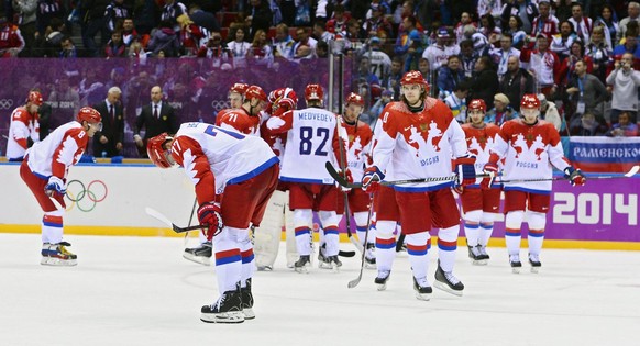 epa04088600 Djected players of Russia after losing to Finland in the quarter final match between Finland and Russia at the Bolshoy Ice Dome in the Ice Hockey tournament at the Sochi 2014 Olympic Games ...