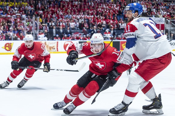 Switzerland&#039;s Kevin Fiala , left, and Switzerland&#039;s Gregory Hofmann, middle, against Czechy`s Michal Moravcik during the game between Czech Republic and Switzerland, at the IIHF 2019 World I ...