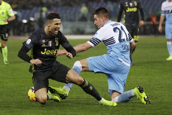 Juventus&#039; Cristiano Ronaldo, left, challenges for the ball with Lazio&#039;s Sergej Milinkovic Savic during the Serie A soccer match between Lazio and Juventus at the Olympic stadium, in Rome, Su ...
