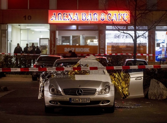 A car with dead bodies stands in front of a bar in Hanau, Germany, Thursday, Feb. 20, 2020. German police say several people were shot to death in the city of Hanau on Wednesday evening. (AP Photo/Mic ...