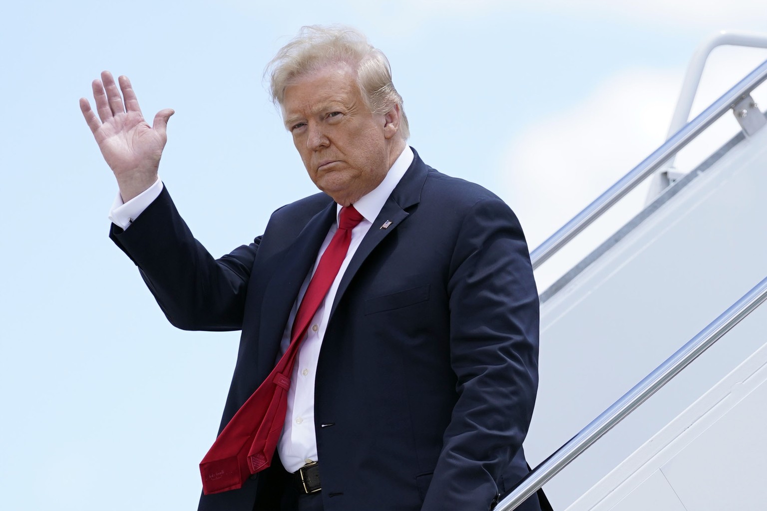 FILE - In this Thursday, June 25, 2020 file photo, President Donald Trump waves as he arrives on Air Force One at Austin Straubel International Airport in Green Bay, Wis. Iran has issued an arrest war ...