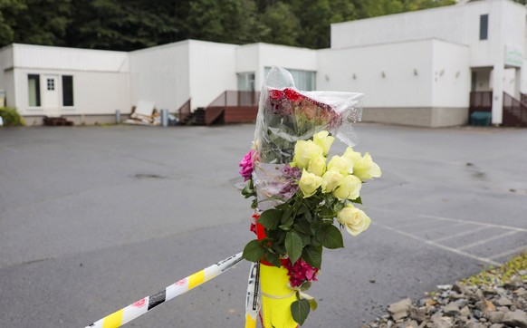 epa07769560 Flowers and police cordon outside Al-Noor Islamic Centre Moque in Barum (Baerum) outside Oslo, Norway, 12 August 2019. A 21-year-old Norwegian man is set to face court on suspicion of kill ...