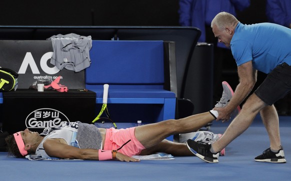 Spain&#039;s Rafael Nadal receives treatment from a trainer during his quarterfinal against Croatia&#039;s Marin Cilic at the Australian Open tennis championships in Melbourne, Australia, Tuesday, Jan ...