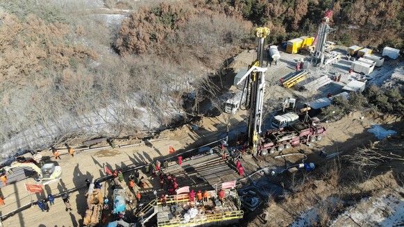 210117 -- QIXIA, Jan. 17, 2021 -- Aerial photo taken on Jan. 17, 2021 shows rescuers drilling a hole at the explosion site of a gold mine in Qixia City, east China s Shandong Province. Twenty-two work ...