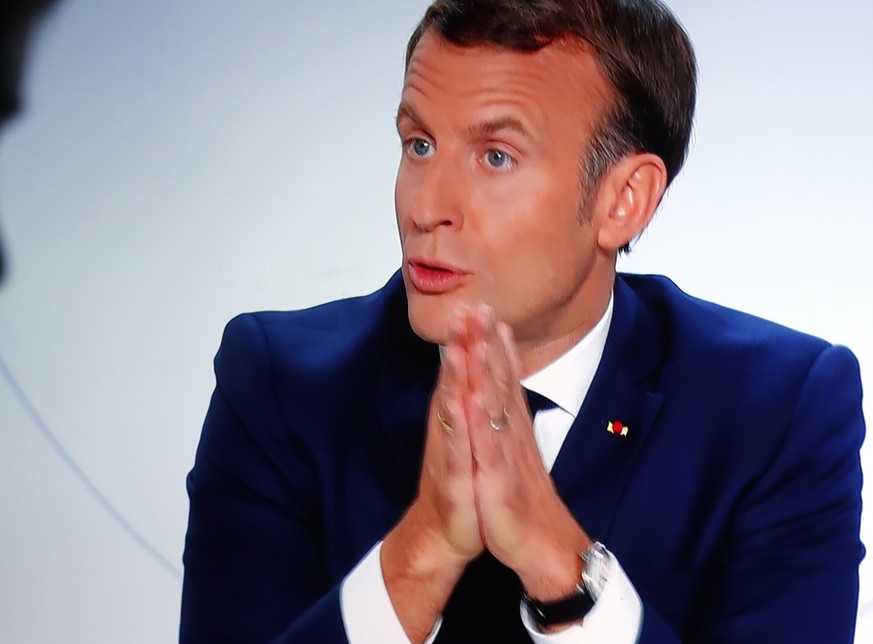 epa08744978 A picture of TV screen shows French President Emmanuel Macron speaking during an interview on the situation of the COVID-19 outbreak, caused by the novel coronavirus, in Vendemian, France, ...