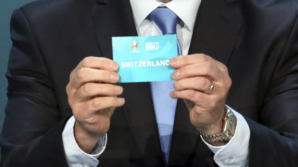 Former Irish soccer player Ronnie Whelan draws Switzerland during the UEFA Euro 2020 European soccer championship qualifying draw at the Convention Centre in Dublin, Ireland, Sunday, Dec. 2, 2018. (AP ...