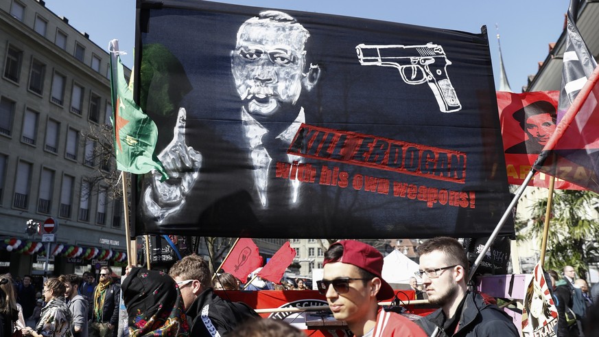 epa05870523 A banner reads; &#039;Kill Erdogan with his own weapons&#039;, as protesters march during a demonstration against the Turkish President Recep Tayyip Erdogan, in Bern, Switzerland, 25 March ...