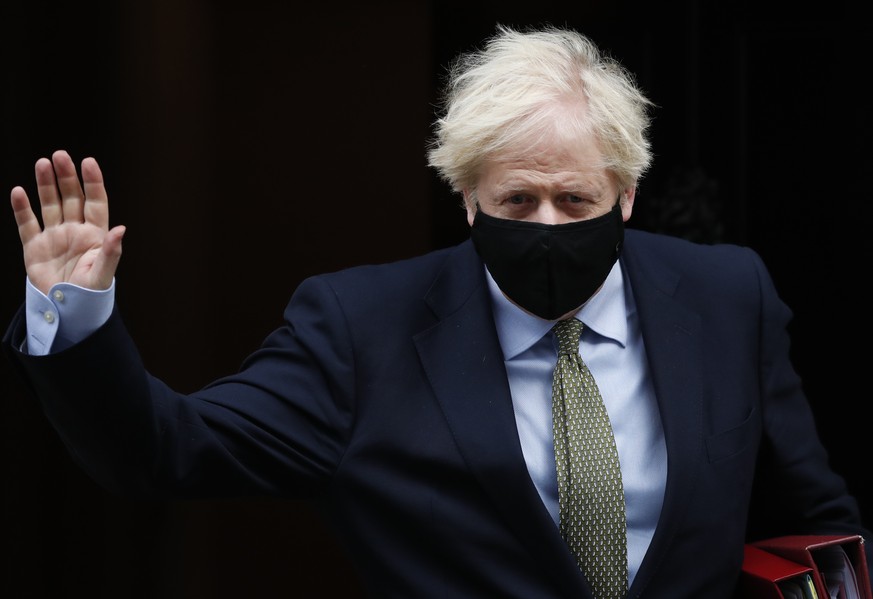 Britain&#039;s Prime Minister Boris Johnson waves as he leaves 10 Downing Street for the House of Commons for his weekly Prime Minister&#039;s Questions in London, Wednesday, Oct. 14, 2020. (AP Photo/ ...