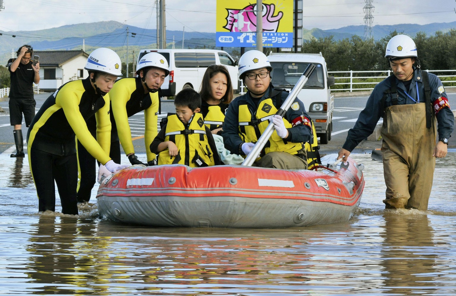 Residents on a rubber boat are rescued as they were stranded by Typhoon Hagibis, in Iwaki, Fukushima prefecture, northern Japan, Sunday, Oct. 13, 2019. Rescue efforts for people stranded in flooded ar ...