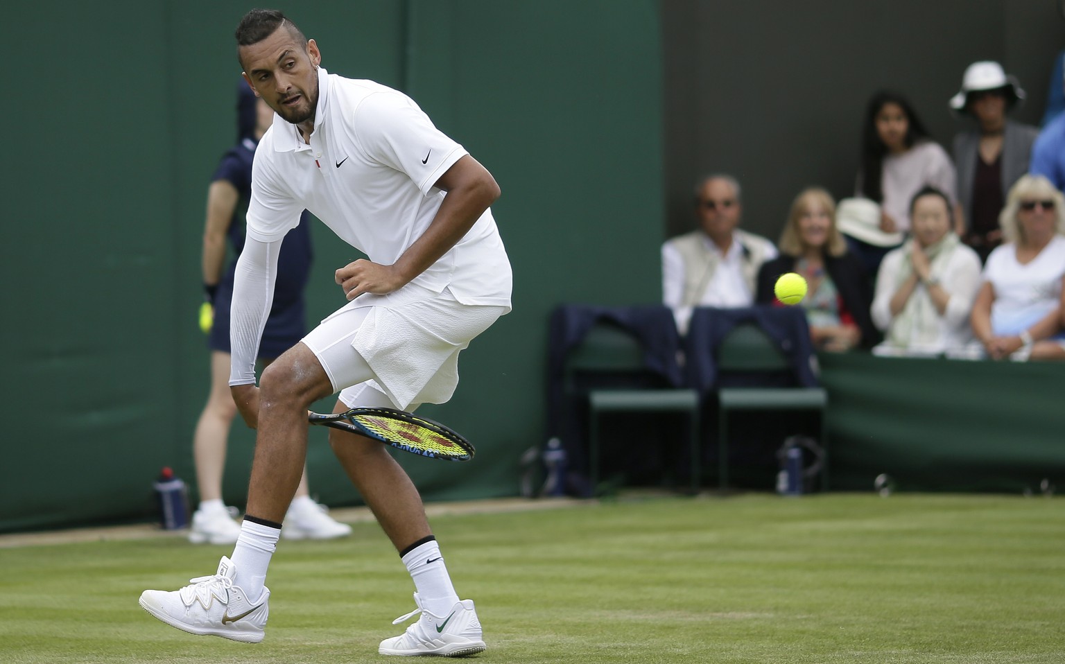 Australia&#039;s Nick Kyrgios returns the ball from between his legs to Australia&#039;s Jordan Thompson in a Men&#039;s singles match during day two of the Wimbledon Tennis Championships in London, T ...