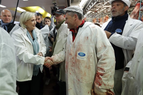 epa05926475 Marine Le Pen, France&#039;s National Front&#039;s (FN) political party candidate for French 2017 presidential election, speaks with employees as she visits the Rungis international food m ...