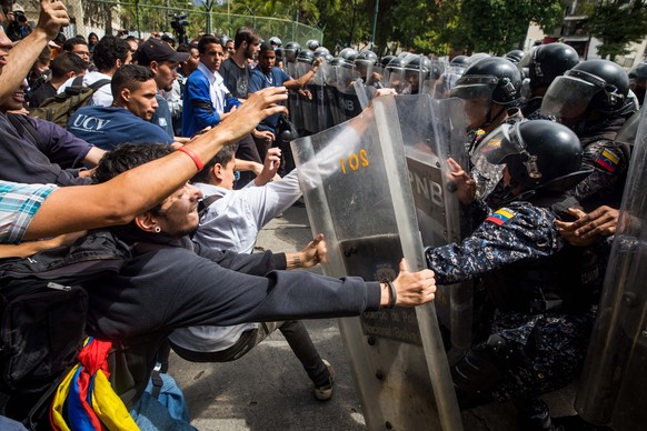 epa07315380 (FILE) - University students clash with the National Bolivarian Police (PNB) during a protest in Caracas, Venezuela, 21 November 2018 (reissued 24 January 2019). Venezuela has fallen into  ...