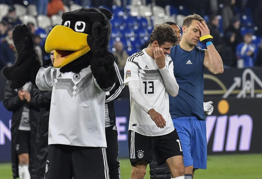 Germany&#039;s keeper Manuel Neuer and Thomas Mueller leave the pitch beside the mascot disappointed after the UEFA Nations League soccer match between Germany and The Netherlands in Gelsenkirchen, Mo ...