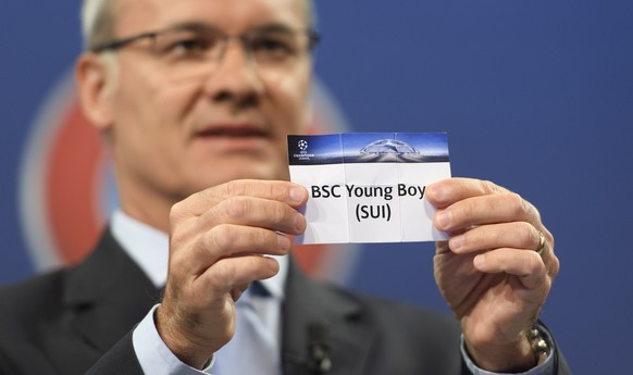 UEFA Competitions Director Giorgio Marchetti shows a ticket with Swiss soccer club BSC Young Boys, during the draw of the play-offs games of UEFA Champions League 2016/17 play-offs, at the UEFA Headqu ...