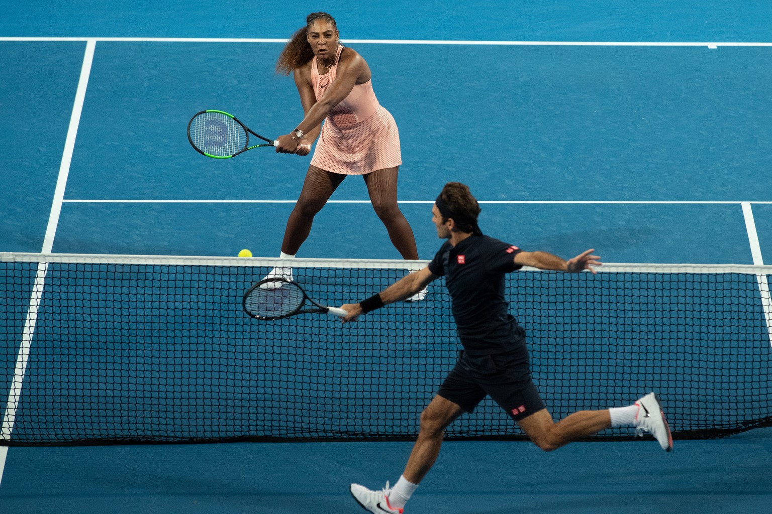epa07257113 Serena Williams of the USA and Roger Federer of Switzerland in action during the mixed doubles match between Roger Federer and Belinda Bencic of Switzerland and Frances Tiafoe and Serena W ...