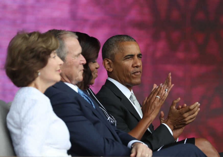 President Barack Obama, right, with, from left, former first lady Laura Bush, former President George W. Bush and first lady Michelle Obama applaud during the opening ceremony of the Smithsonian Natio ...